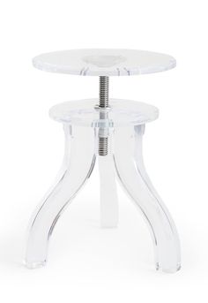 an acrylic table with two clear legs and a round glass plate on top