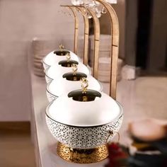 a row of white dishes sitting on top of a counter