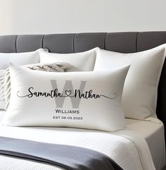 the personalized pillow is on top of the bed with white sheets and black lettering