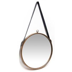 a round mirror hanging on the wall with a leather strap around it's neck