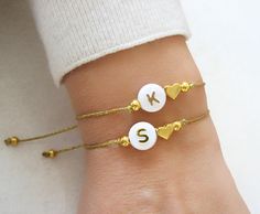 Heart Initial Bracelet, Couples Bracelet, Heart Bracelet, Friendship Bracelet, Adjustable Cord Bracelet, Girlfriend Bracelet ♥Buy 2 Jewelry and Get 1 FREE♥ CODE: GET1FREE Put all 3 items in your cart and apply shop coupon code at checkout. In this way 1 item will be free of cost as you will receive 33% discount. (Except Category 925 Silver Necklaces) A lovely bracelet which you can wear alone or together with others! ♥ Made from 7mm gold plated heart charm, 8mm acrylic initial bead and two gold Adjustable Heart Bracelet Gift, Cute Adjustable Personalized Heart Bracelet, Adjustable Gold Heart Bracelet With Letter Beads, Personalized Adjustable Heart Bracelet, Personalized Initials Bracelet For Valentine's Day, Adjustable Heart-shaped Charm Bracelet With Letter Beads, Aniversary Gifts, Rhinestone Choker Necklace, Couples Bracelet