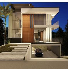 a car is parked in front of a modern house at night with stairs leading up to the entrance