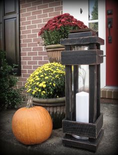 a wooden lantern sitting next to a pumpkin