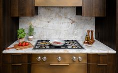 a stove top oven sitting inside of a kitchen next to wooden cabinets and counter tops