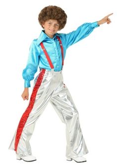 a young boy dressed in an elvis costume, pointing at something with his right hand