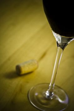 a wine glass sitting on top of a wooden table