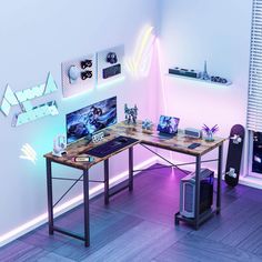 a computer desk with two computers on top of it next to a guitar case and other items