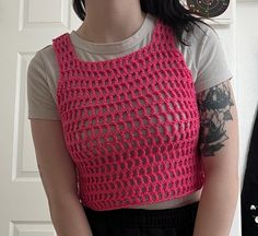 This is a cute pink mesh tank top, crocheted by myself with acrylic yarn that I got from the thrift store! Pink Stretch Crochet Top Casual Style, Pink Open Knit Crochet Top For Spring, Pink Crochet Top For Spring, Spring Pink Crochet Top With Knit Fabrication, Sleeveless Crochet Lace Knit Crop Top, Pink Crochet Crop Top For Spring, Pink Spring Crochet Crop Top, Summer Knit Pink Crop Top, Pink Knit Crop Top For Summer