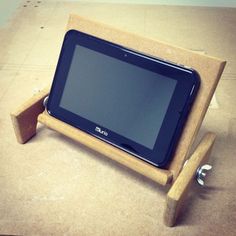 a tablet sitting on top of a wooden stand