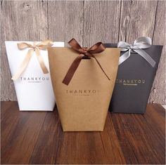 three thank you bags tied with brown ribbon