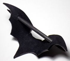 a black bat shaped object with a long blade sticking out of it's back