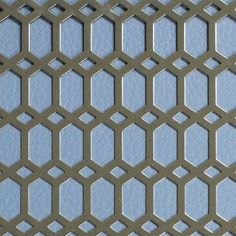 a close up view of a metal grate with hexagonal holes