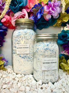 two mason jars filled with blue and white confetti