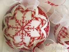 some ornaments are sitting on top of each other in red and white checkered fabric