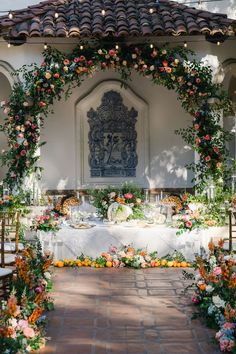 an outdoor wedding setup with flowers and greenery