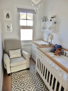 a baby's room with a crib, chair and window