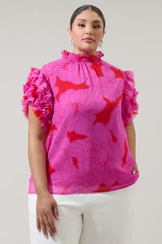 Our most loved and best-selling Brenna Mock Neck Ruffle Blouse makes its return one more time and now in this stunning red and pink floral print. Its silhouette highlights a ruffle-smocked mock neck that tops a ruffle layer sleeve and relaxed bodice. Wear it tucked in to your favorite high waisted flares and strappy heels or sandals. - Mock neck- Ruffle layer sleeves- Keyhole- Classic fit- Color: Red PinkSize + Fit - Model is 5'11" and wearing size 2X- Measurements taken from size 2X - Chest: 49 Pink Ruffle Sleeve Top With Floral Print, Feminine Floral Print Top With Ruffle Sleeves, Red Ruffled Feminine Tops, Feminine Printed Ruffle Sleeve Blouse, Pink Feminine Top With Ruffles, Red Feminine Ruffle Top, Red Feminine Ruffled Tops, Feminine Red Ruffled Tops, Feminine Pink Ruffled Tops