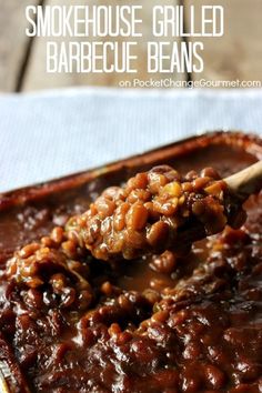 a spoon full of barbecue beans in a casserole dish with text overlay