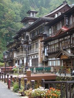 a row of wooden buildings sitting on the side of a road