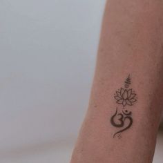 a woman's arm with a tattoo on the wrist and an omen symbol