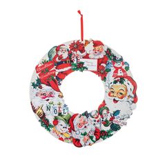 a christmas wreath ornament hanging from a red ribbon with santa claus and other holiday decorations on it