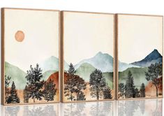 three canvases with trees and mountains in the background, each painted on different colors