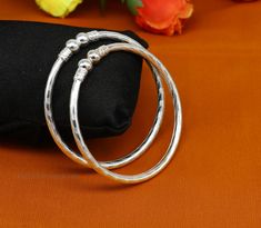 Exclusive vintage unique design handmade sterling silver bangle. We can easily wear it by twisting both face of bangle, amazing stylish bangle bracelet, both men's and women's can wear it, best personalized gifting article from India. Metal-sterling silver. Item type-Bangle. Weight-22.780 grams. Size-2-4 or 2.25 inches or 5.7 centimeters. Width of bangle-5mm approx. Make excellent gifting and collectible pieces(gift for birthday, wedding, anniversary, mother's day, fathers day, Christmas day,) W Bangle For Men, Bangles Jewelry Designs Silver, Silver Kada Design, Kada Bangles Silver Design, Silver Bangles For Women, Handmade Fusion Style Round Bangle, Silver Kada Women Simple, Silver Bangles Design For Women, Fusion Style Round Bangle As A Gift