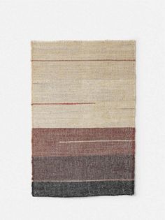 a multicolored area rug on a white background with red, brown, and black stripes