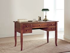 a wooden desk with two drawers and a lamp on top