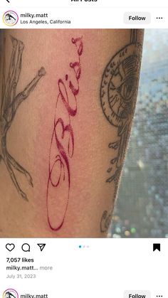 a tattoo on someone's leg with the word love written in cursive writing