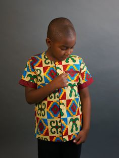 This short sleeved African Kente shirt is real cute. Dress him up in this cute African outfit and he will attract a lot of attention and draw tons of compliments. He can wear it whenever he wants to project his African Identity. He can wear it during Sankofa, Kwanzaa, and any African American or Afrocentric Cultural event. *Hand Sewn African Dress *Made by Local Artisans in Africa *100% Cotton *Made in Ghana *Portions of proceeds donated to charities in Africa *Everything in stock is available i Printed Cotton Half Sleeve T-shirt, Multicolor Printed Camp Shirt With Short Sleeves, Multicolor Printed Short Sleeve Camp Shirt, Multicolor Short Sleeve Camp Shirt With Print, Short Sleeve Shirt With Graphic Print, Patterned Cotton Short Sleeve T-shirt, Cotton Half Sleeve Shirt With Graphic Print, Green Blouse With Graphic Print And Short Sleeves, Green Short Sleeve Blouse With Graphic Print