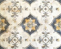 an ornate wallpaper pattern with gold and silver flowers on white, blue, and black background