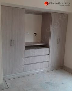 an empty room with some cupboards and drawers on the floor in front of it