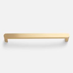 a brass cabinet handle on a white background with no one in the room to see it