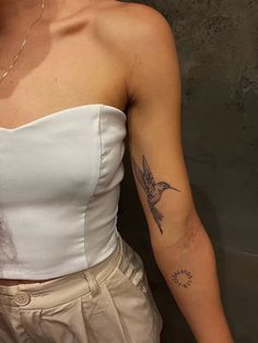 a woman with a bird tattoo on her arm