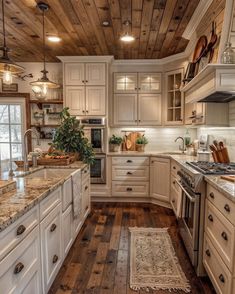 a large kitchen with white cabinets and wood flooring on the walls, along with wooden ceiling beams