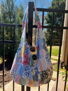 a handbag hanging on a gate with trees in the background