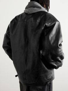 Balenciaga's 'Cocoon Kick' jacket is made from smooth black leather that's crinkled in places for a vintage appearance – the brand has a department dedicated to giving its pieces an aged look. It's lightly padded for both warmth and to enhance its oversized shape. Designer Black Oversized Outerwear, Designer Oversized Black Outerwear, Black Designer Oversized Outerwear, Oversized Leather Outerwear For Streetwear, Luxury Leather Outerwear For Streetwear, Hooded Leather Jacket For Work, Oversized Leather Biker Outerwear, Luxury Oversized Outerwear, Oversized Urban Leather Outerwear