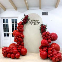 a bunch of red tomatoes sitting on top of a table next to a white door