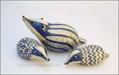 three ceramic birds sitting next to each other