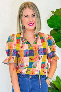 This cheerful gingham print, sprinkled with playful floral tulips, is just the thing to brighten up any day. Whether you're headed to a sunny picnic, a lively brunch with friends, or a casual day out, this top pairs perfectly with your favorite denim for a look that's effortlessly stylish. The button-down front adds a touch of vintage charm, making it a versatile piece that will keep your outfits fresh and fun all season long. PRODUCT FIT - TRUE TO SIZE MODEL DETAILS - BRENNA IS WEARING A SIZE S Casual Multicolor Blouse For Garden Party, Trendy Tops For Spring Garden Party, Patterned Floral Print Top For Brunch, Trendy Ditsy Floral Print Tops For Spring, Trendy Tops For Summer Garden Party, Floral Print Tops For Spring Garden Party, Floral Print Blouse For Spring Garden Party, Spring Garden Party Blouse With Floral Print, Playful Patterned Summer Tops