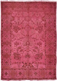 an antique pink rug with floral designs on the center and sides, all in different colors