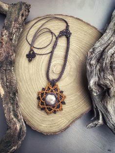 Tribal style necklace with a rounded-shaped Flower Jasper cabochon of 1.5 cm in diameter, with pink and red veins on a light background. Setting and processing in Micro Macramé technique, made of natural earthy shades of dark purple and mustard. Waxed polyester threads. Embellished and adjustable cord with sliding knot closure. With the addition of nickel-free brass beads. Ornament Gift Woman. Flower Jasper stone helps to reconnect with the Earth element, encouraging action. It brings resolve an Flower Pendant Necklace With Adjustable Cord, Bohemian Round Jewelry With Adjustable Length, Handmade Brown Flower Pendant Jewelry, Handmade Round Necklace For Festivals, Macrame Pendant Amulet Necklace, Macrame Amulet Pendant Necklace, Amulet Style Macrame Pendant Necklace, Festival Macrame Pendant Necklace, Unique Macrame Pendant Necklace