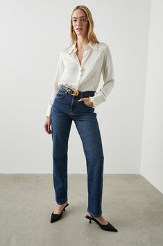 Made 100% from silk charmeuse, the Fia top is a luxurious button-up with dainty ruffle detailing on the cuffs, button placket, and collar. Style with the Rails Topanga jeans and a pair of loafers. Elegant Straight Leg Jeans With Button Closure, Elegant Denim Jeans For Fall, Elegant Jeans For Fall, Elegant Denim Bottoms For Workwear, Classic Button-up Jeans For Workwear, Classic Formal Jeans For Spring, Classic Formal Jeans For Fall, Elegant Fitted Jeans For Formal Occasions, Elegant Business Casual Jeans For Fall