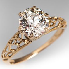 an antique style diamond ring with filigrees