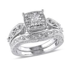 a wedding ring set with an intricate design on the band and center stone in white gold