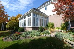 a house with lots of windows in the front yard