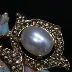 *Description: This is a beautiful vintage Sarah Coventry brooch & pendant combination from the 1960s. The diamond shaped brooch has a turquoise egg shaped cabochon with gold glitter streaked through it. It also has a little touch of white. There are matching small faceted stones , two on each of the four sides. There are four large faux pearls near each corner. This would be a great brooch or pendant to wear with any outfit. This would also make a great vintage gift. *Approximate Measurement Sarah Coventry, Diamond Shaped, Turquoise Pendant, Coventry, 1960s Vintage, Vintage Gifts, The Four, The 1960s, Gold Glitter