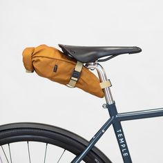 a close up of a bike with a bag on the back