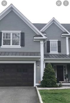 a gray house with white trim and black shutters